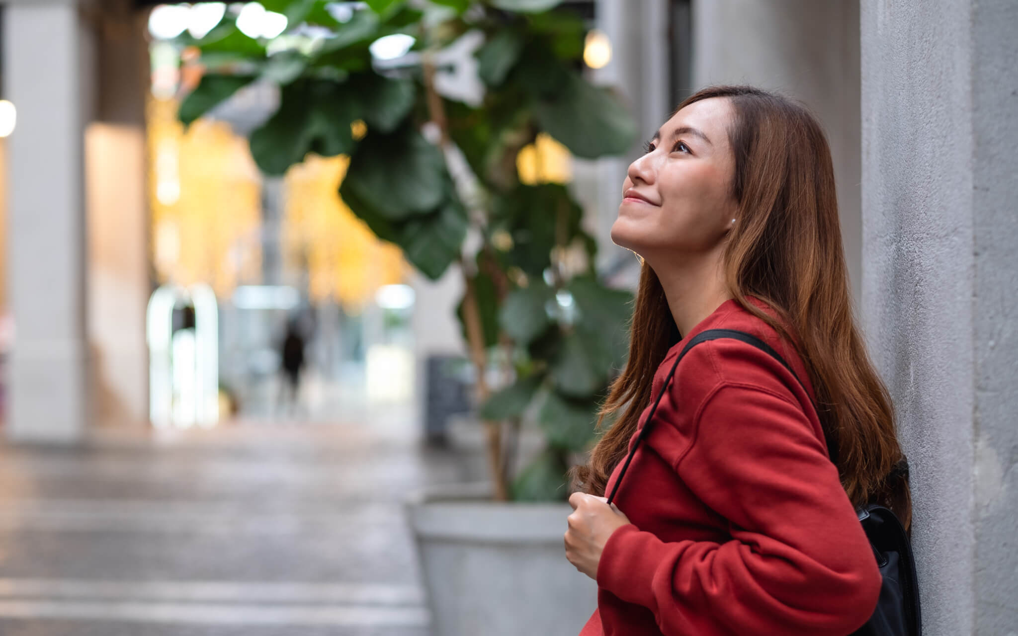 A young asian woman walking on the street while traveling and sightseeing around the city