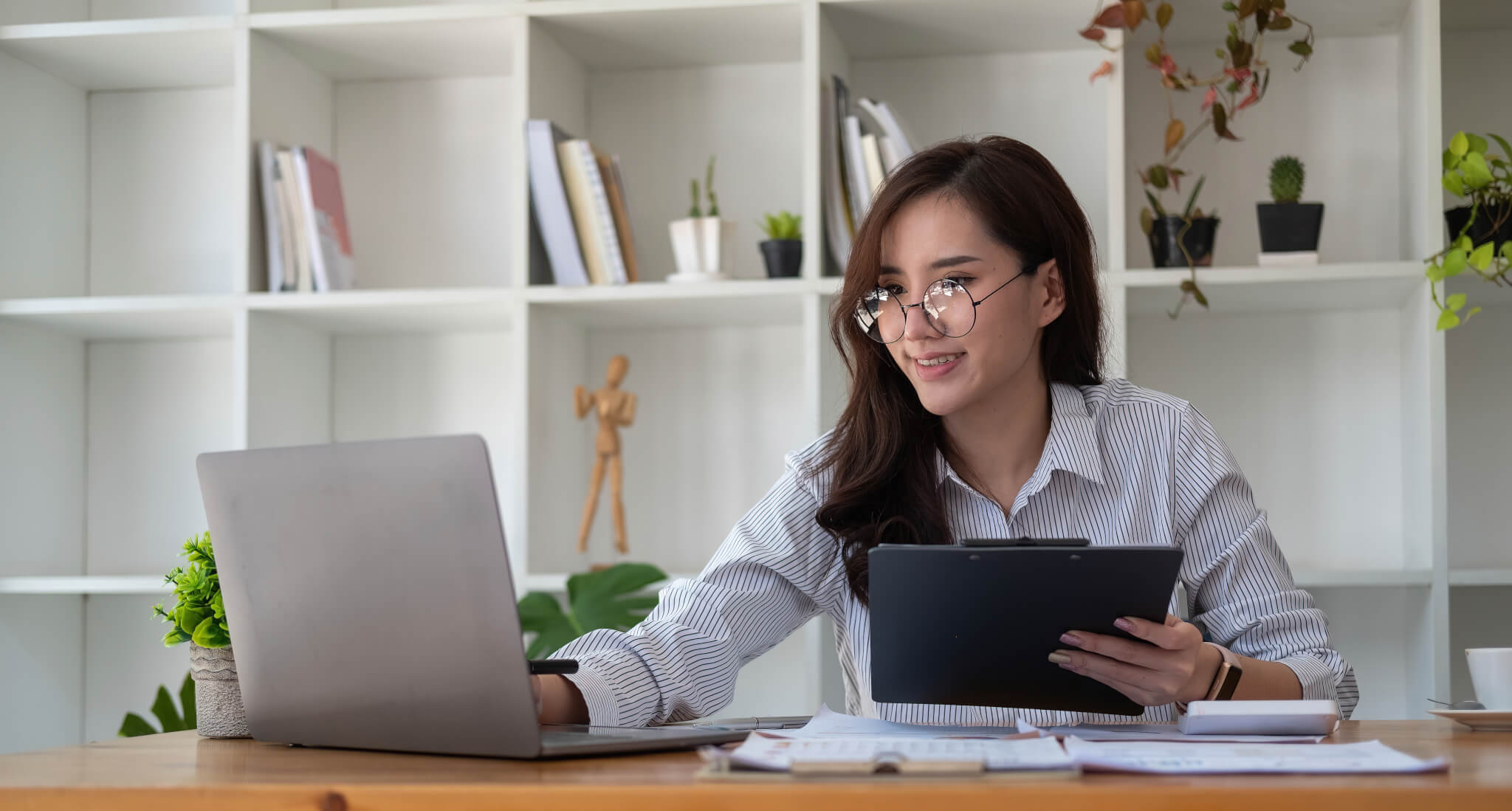 Close up accounting woman working for financial report with laptop and calculator