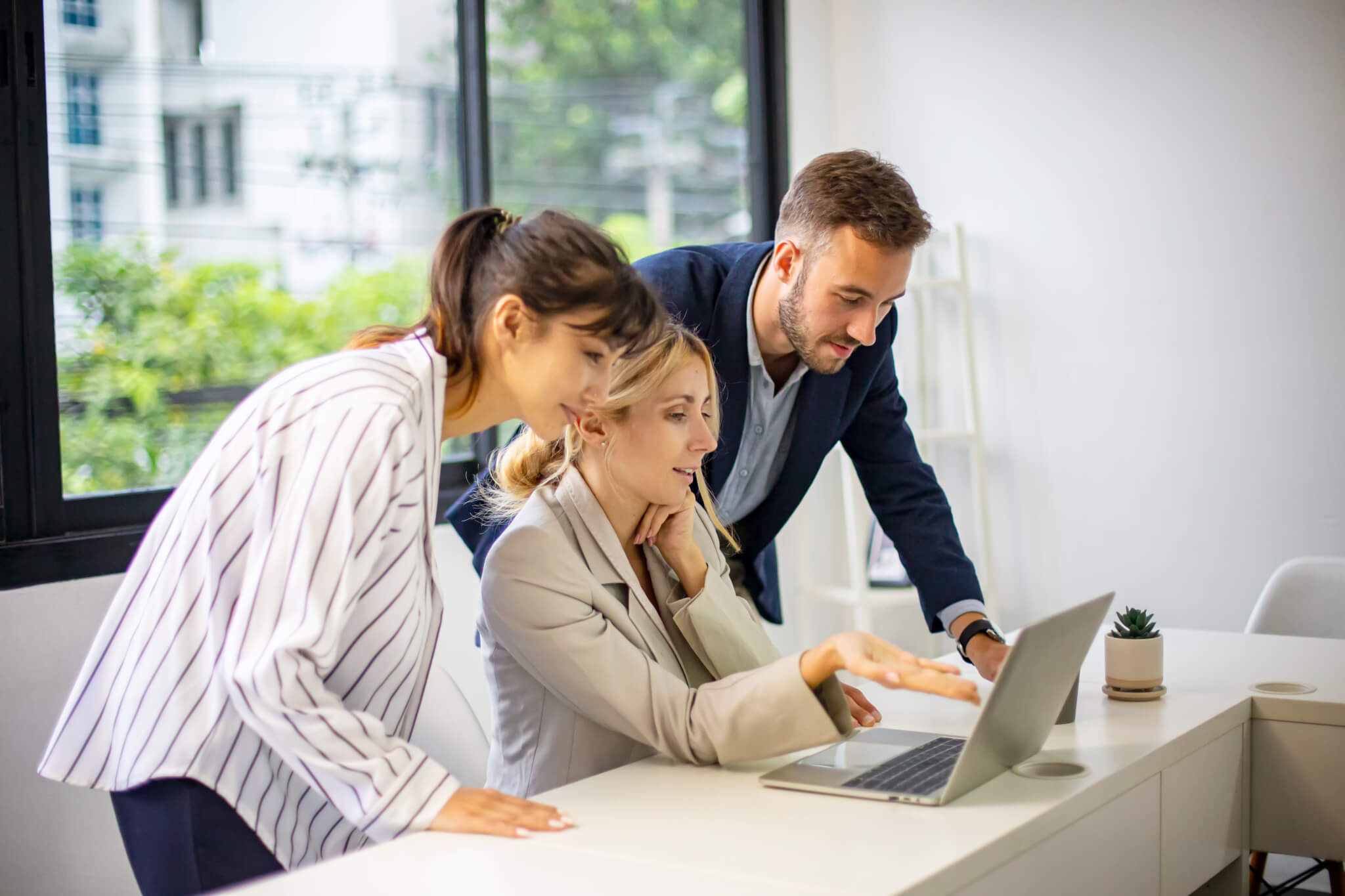 Shot of a mature businesswoman sitting and training her team in the office.